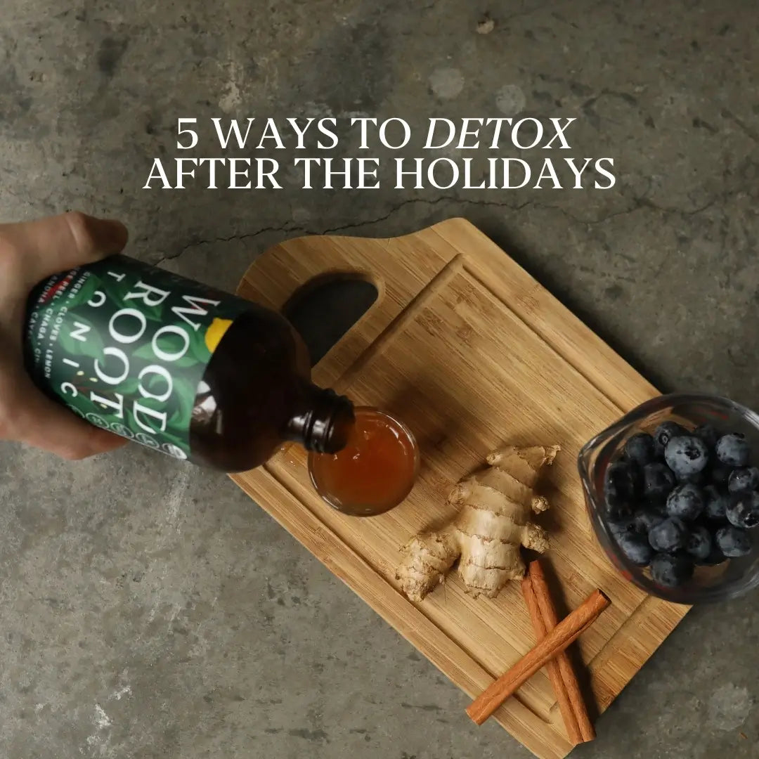 Natural gut shot, Woodroot Tonic, being poured into shot glass on a cutting board with anti-inflammatory ingredients.