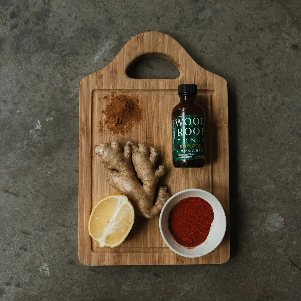Photo of Woodroot Tonic on the go shooters next to anti-inflammatory ingredients. 
