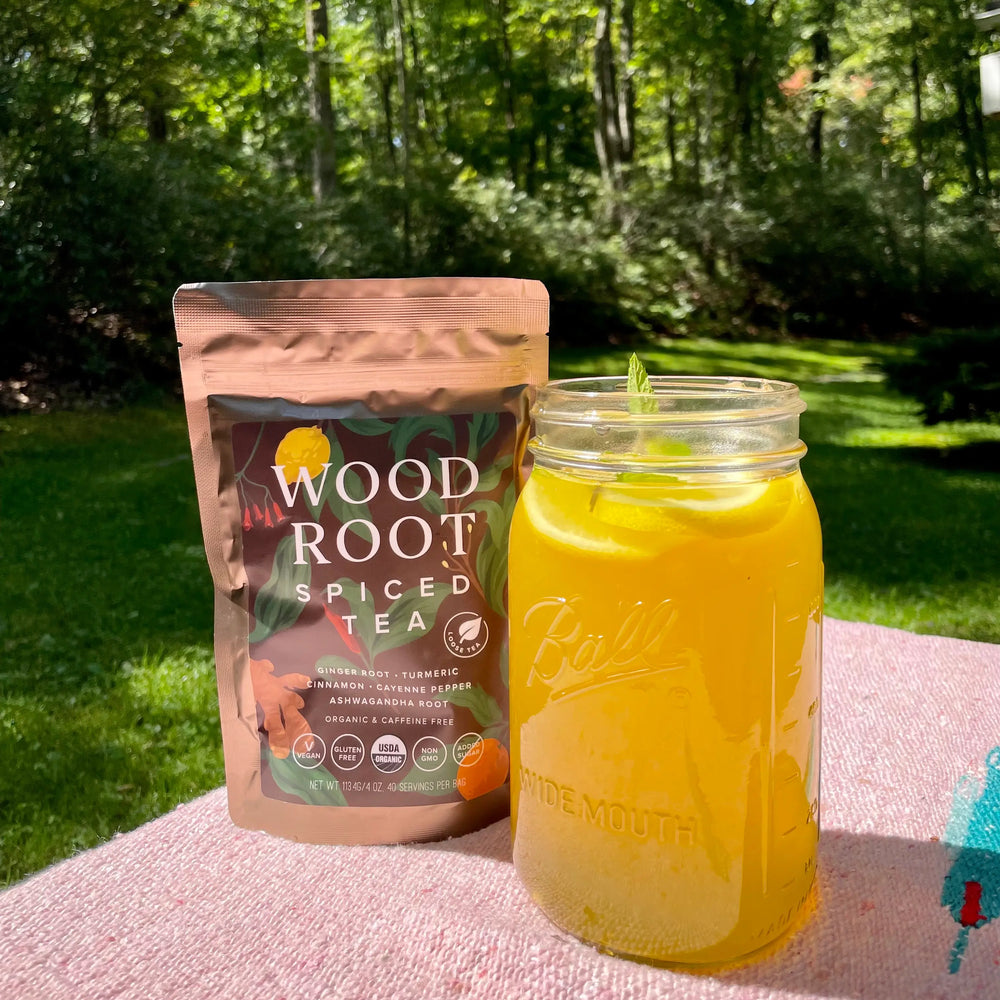Woodroot Spiced Tea mixed with herbs and lemon to create a summer iced tea.