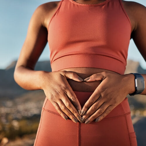 Woman holding happy healthy gut.