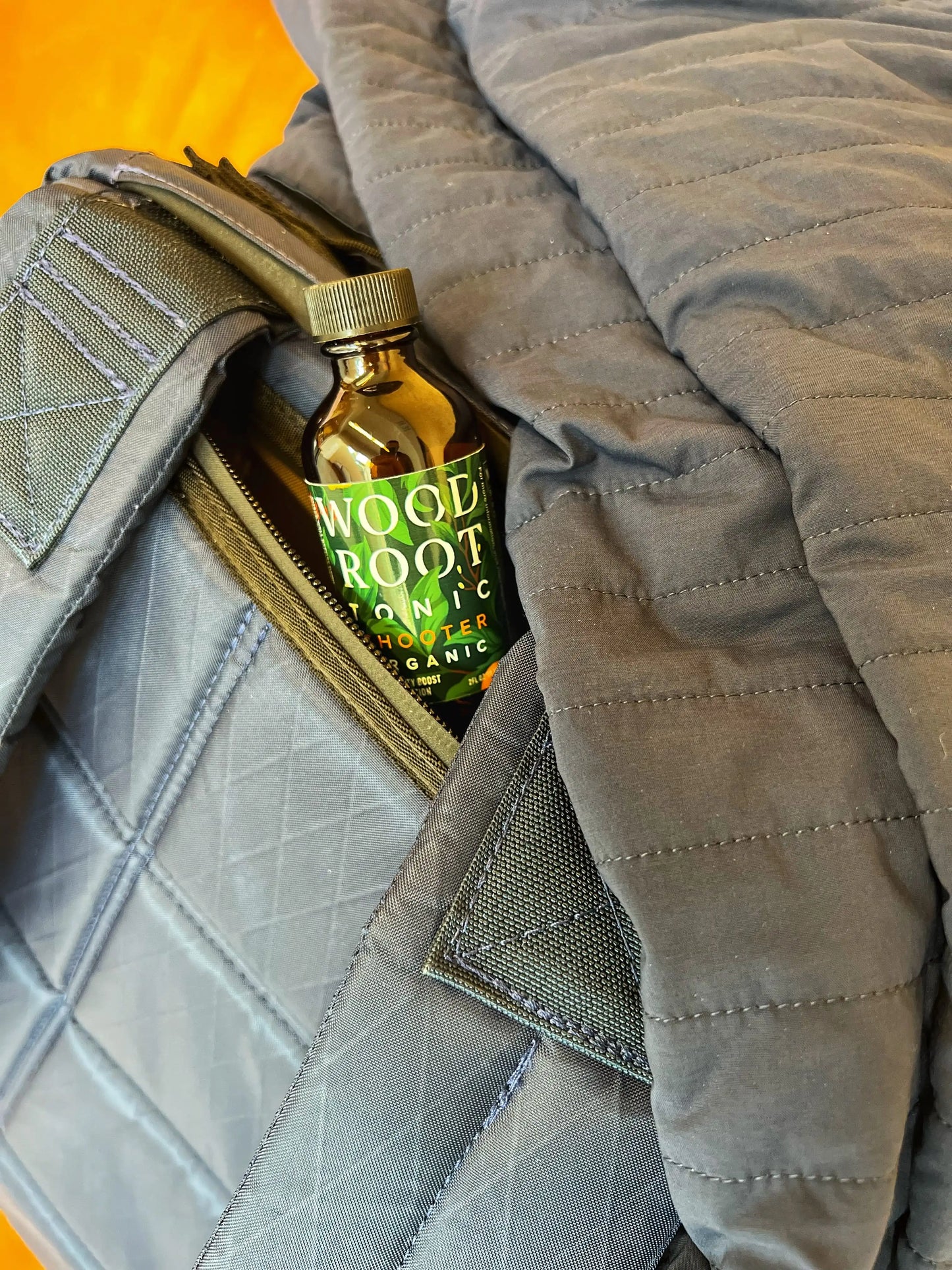 
                  
                    Woodroot Tonic shooter in a backpack being taken to work.
                  
                