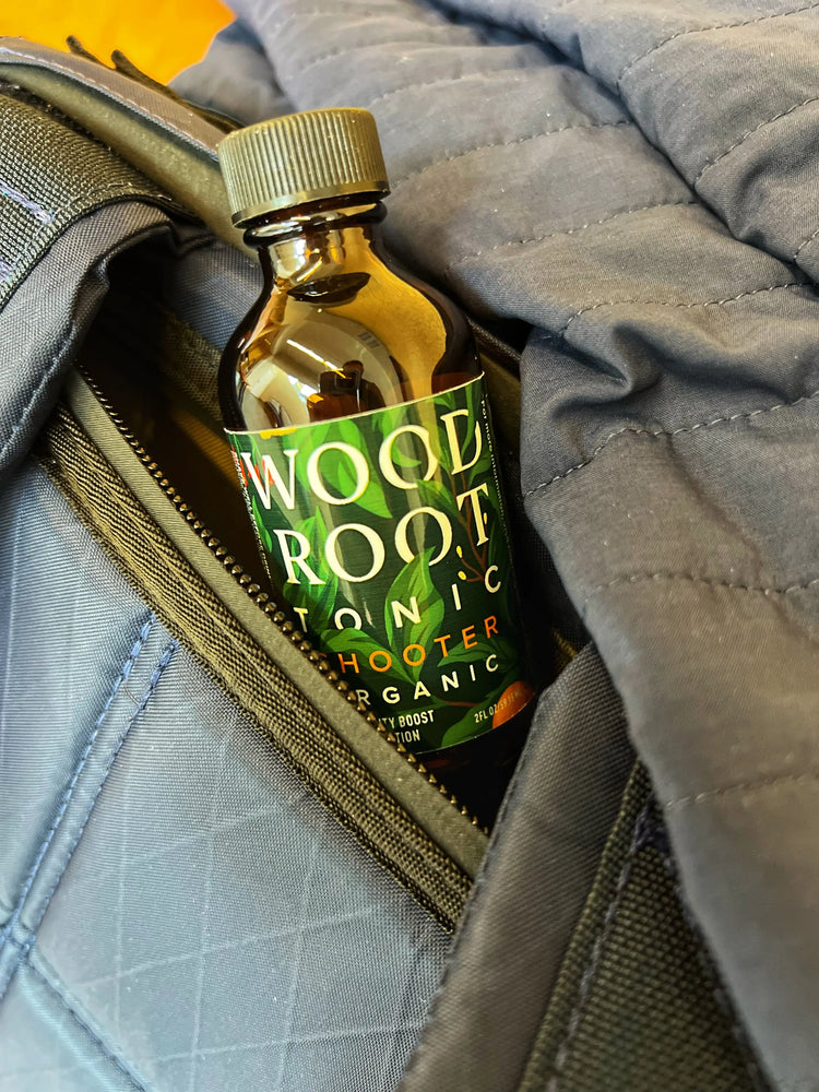 
                  
                    Woodroot Tonic shooter sticking out of a bag as its taken on the go.
                  
                
