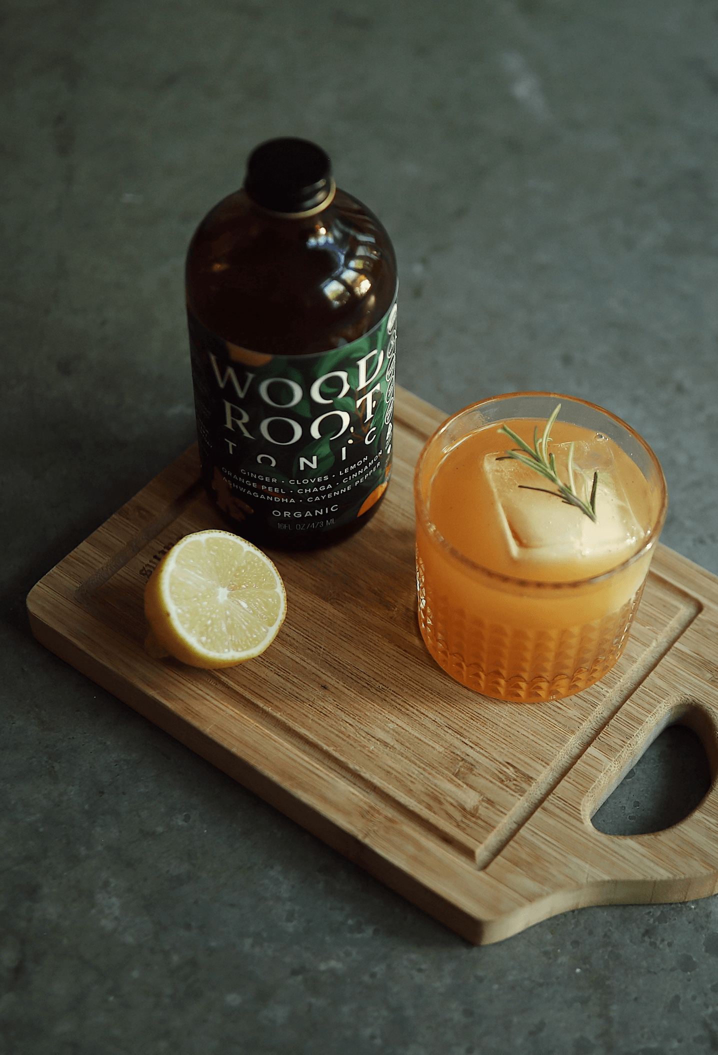Bottle of Morningside Natural's Woodroot Tonic next to cup with a gut healthy mocktail.