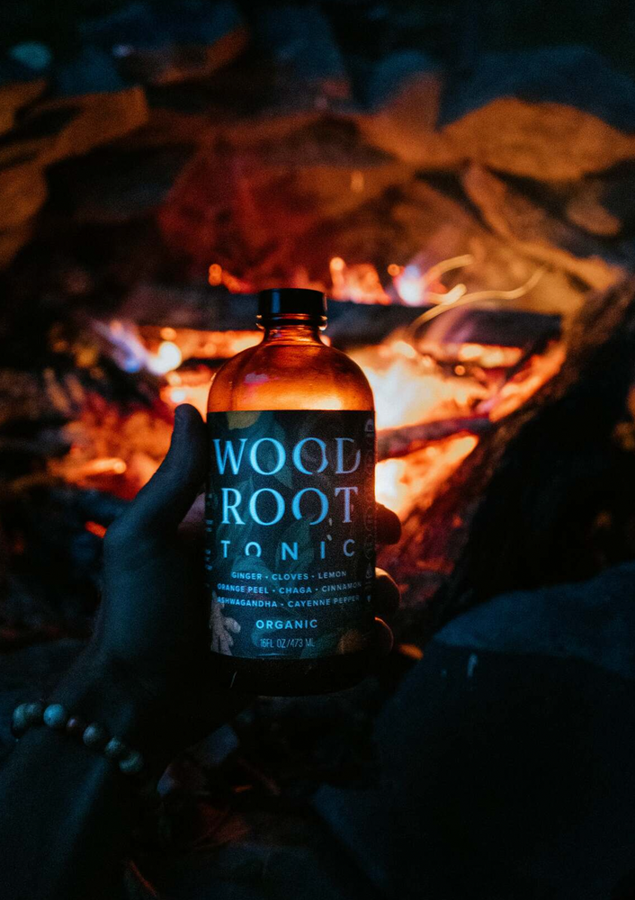 Bottle of Woodroot Tonic next to fire.