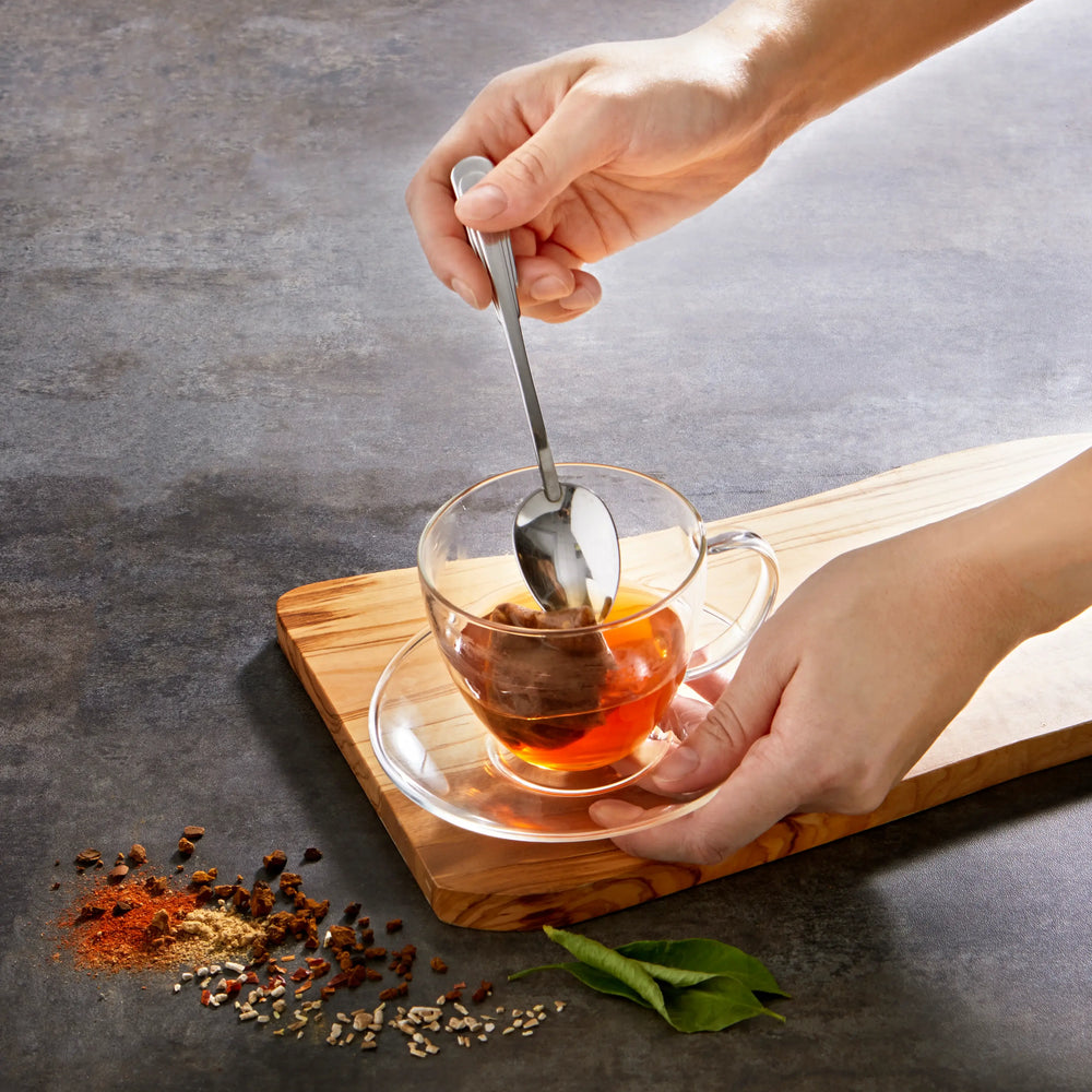 
                  
                    Hand using spoon to pull tea bag out of tea cup.
                  
                