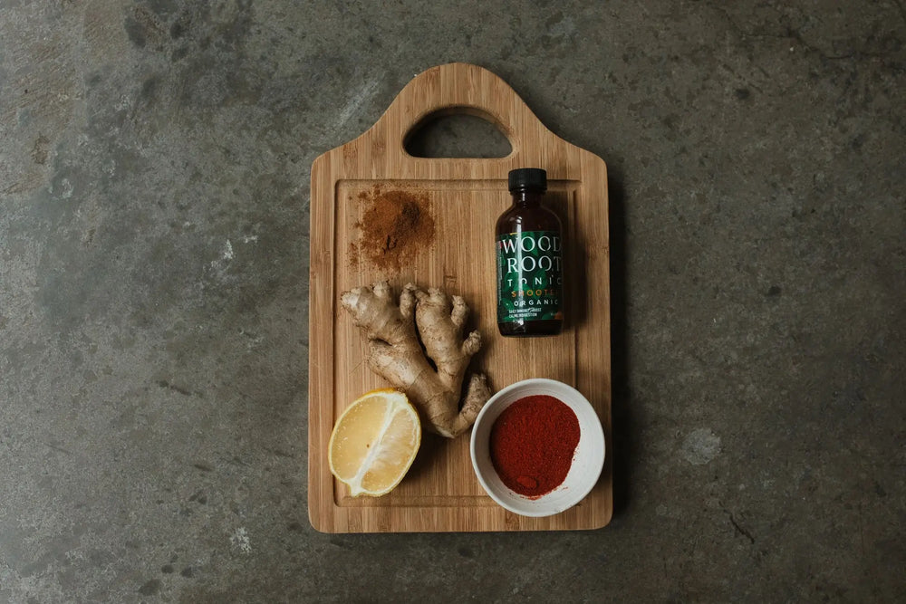 Photo of Woodroot Tonic on the go shooters next to anti-inflammatory ingredients. 