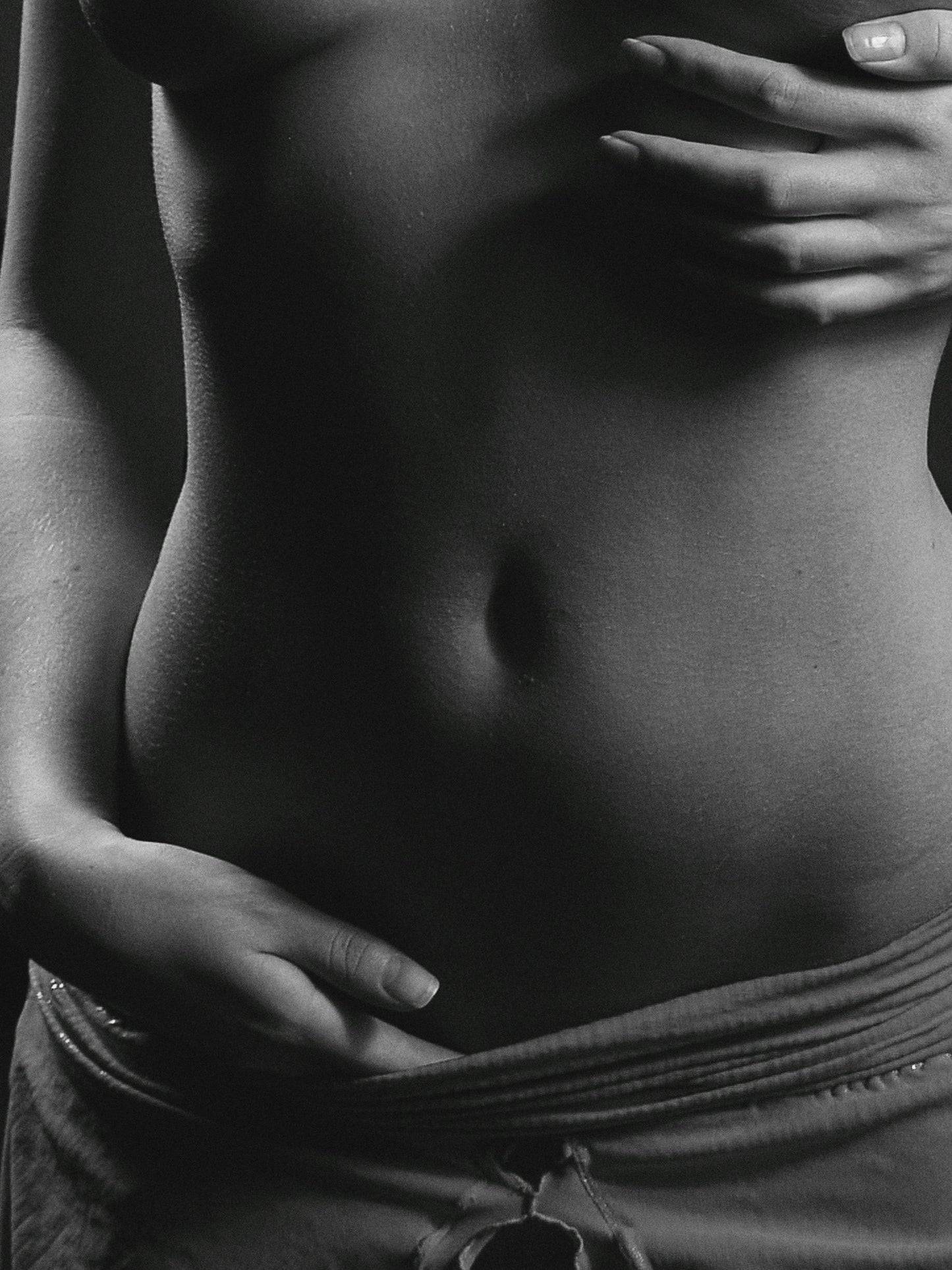 Woman holding stomach experiencing digestive issues. 