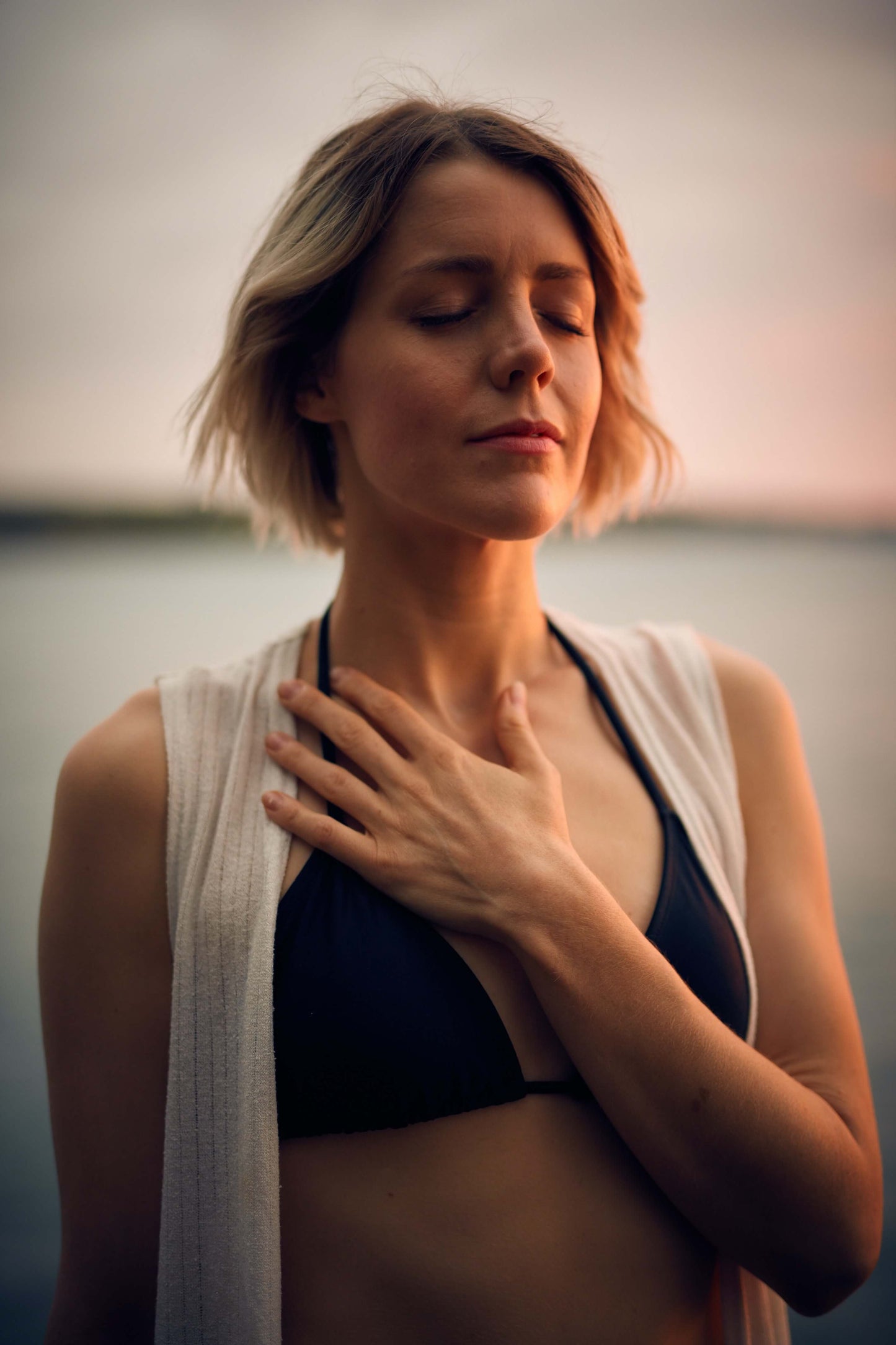 Woman with hand on her heart.
