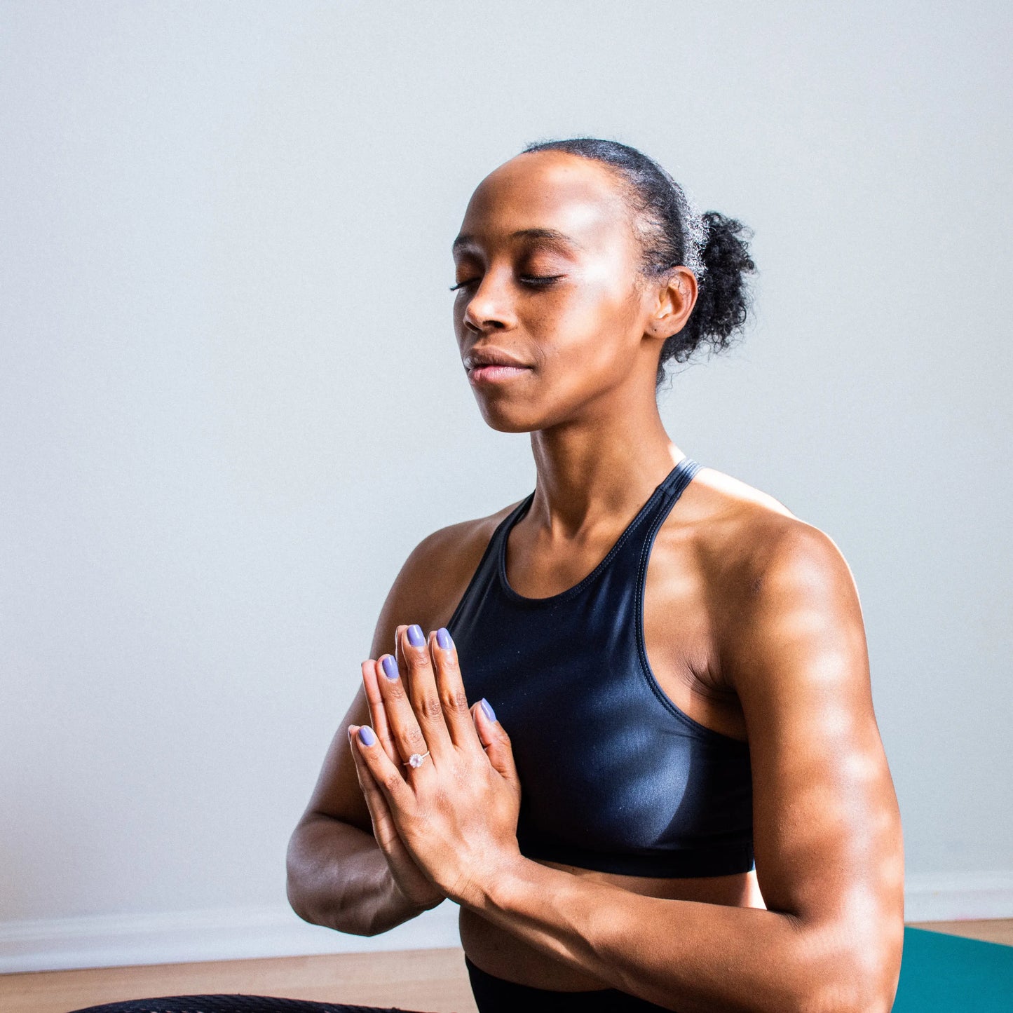 woman meditating with hands in front of her chest. 